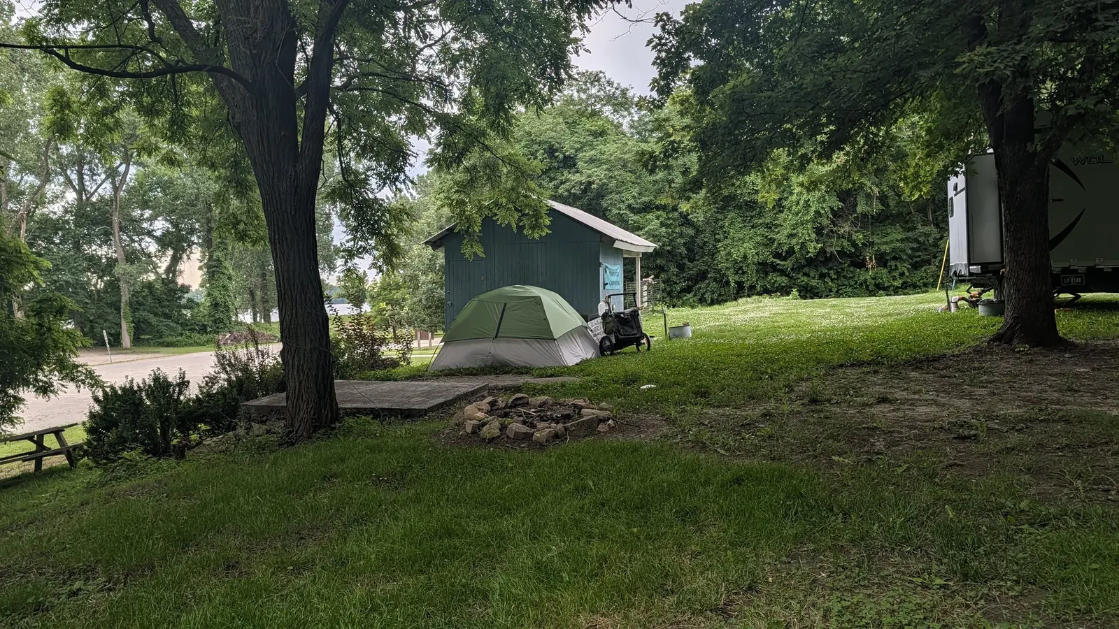 Expedition tent and cart at a shaded campsite